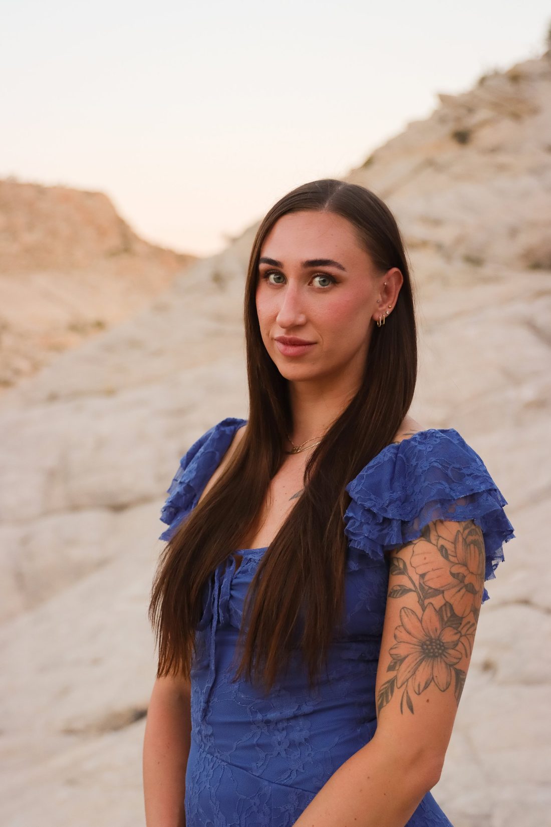 Cheyenne in a blue lace dress in front of the white slickrock near St. George, Utah