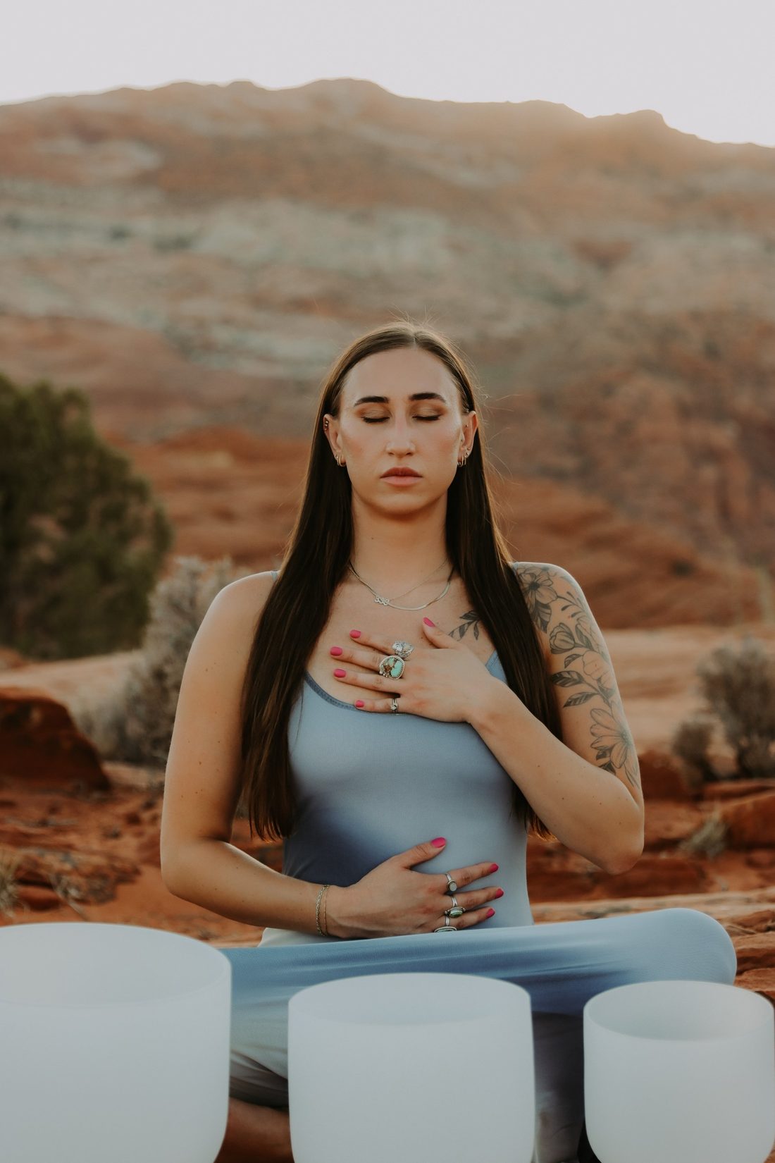 Cheyenne meditating with crystal sound bowls in the red rock desert